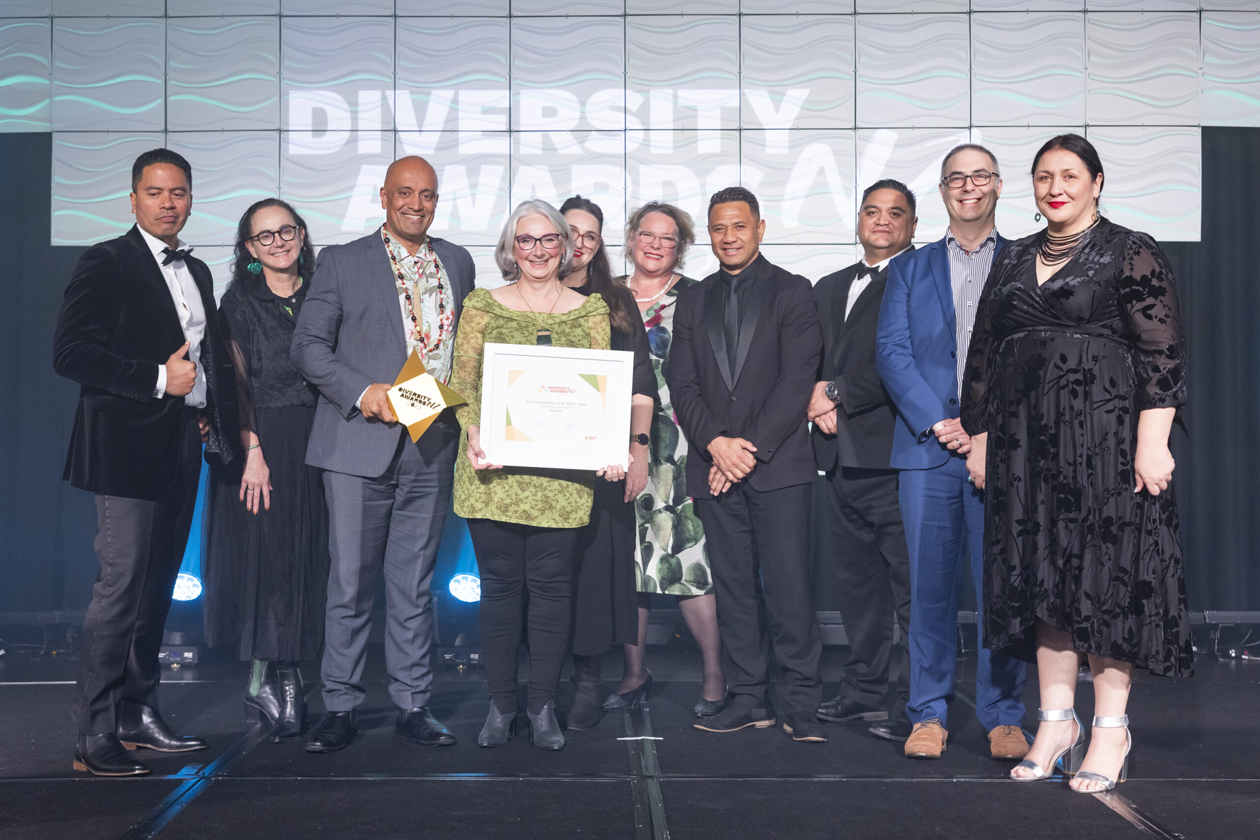 Te Kāhui Pou (the executive leadership team) accepting the diversity award as a group from judge Dr. Nicola Ngawati